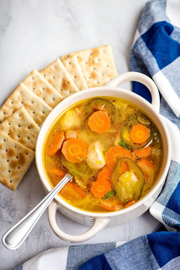 close up of homemade chicken and vegetable soup with spoon 