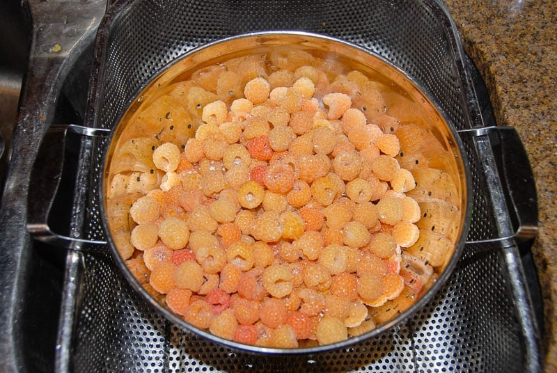 golden raspberries in colander