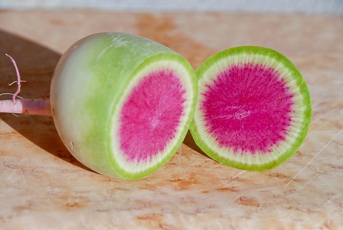 halved Watermelon Radish with green exterior, white ring and pink center