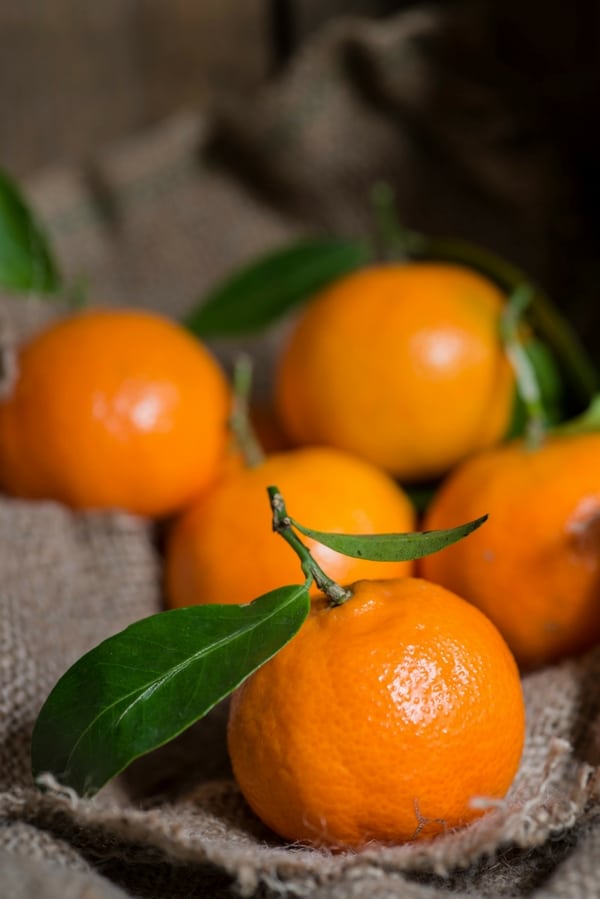 A bowl of oranges on a table