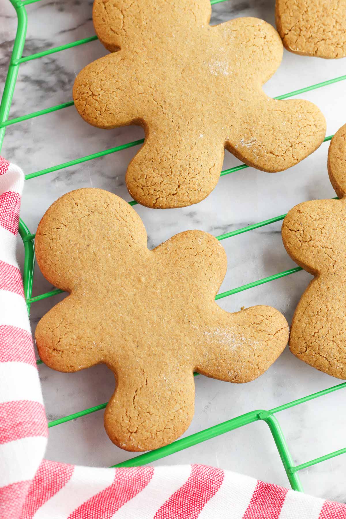 pile of gingerbread man cookies on rack