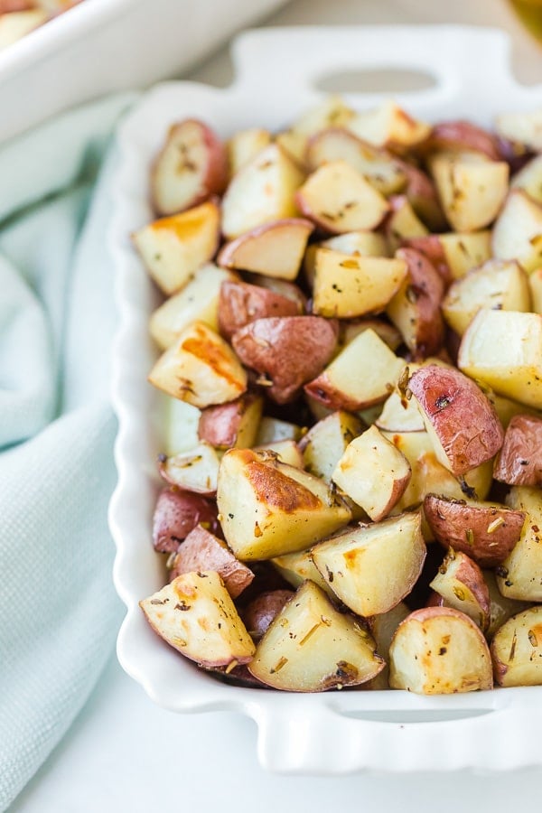 roasted potatoes in white casserole dish