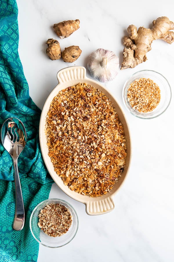 Scalloped Jerusalem Artichokes in pan with ingredients