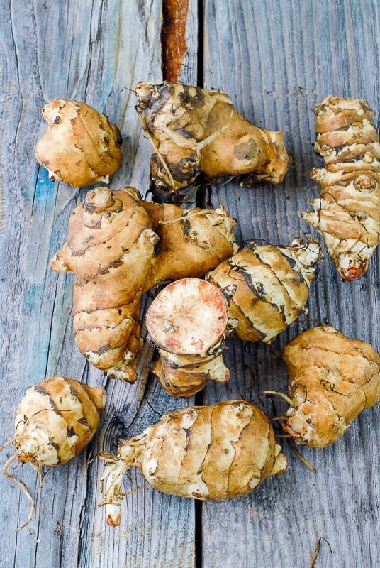 Raw Sunchokes or Jerusalem Artichokes on wood