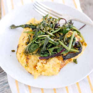 polenta on plate with sautéed greens