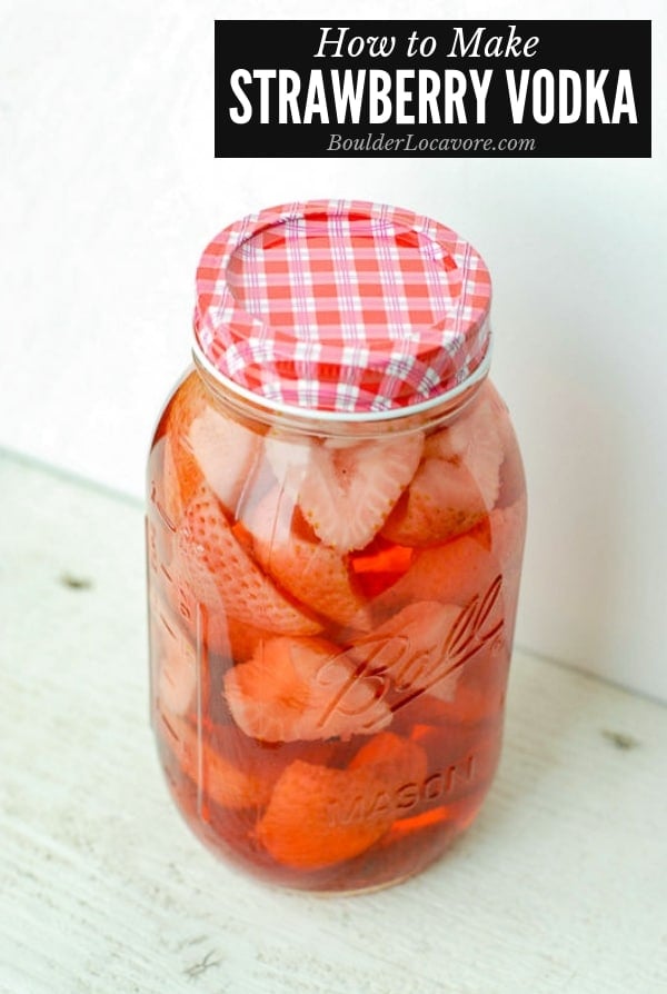 A close up of jar of strawberry vodka