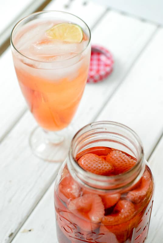 Jar of strawberry infused vodka and a cocktail