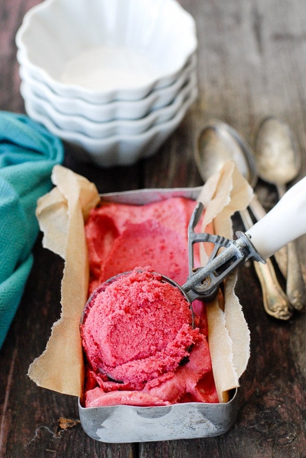 Plum Rosemary-Gin Sorbet in a metal pan with ice cream scoop