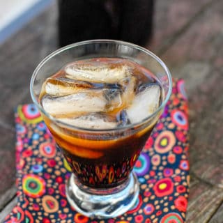 Glass of Coffee Liqueur over ice with colorful napkin