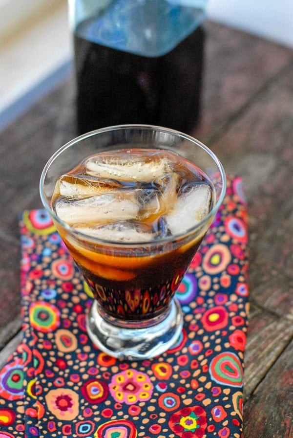 Glass of Coffee Liqueur over ice with colorful napkin