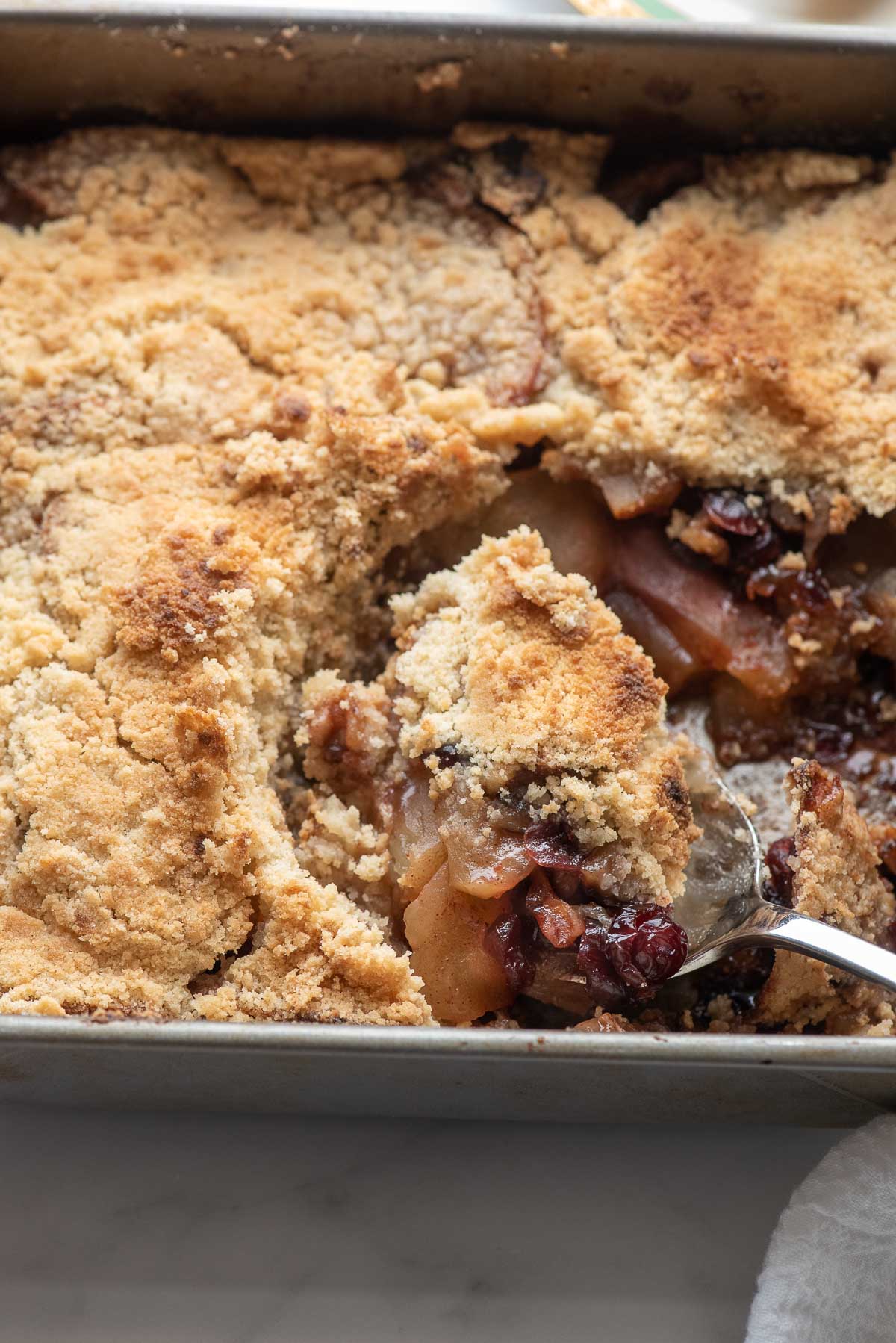 apple crisp in pan with scoop