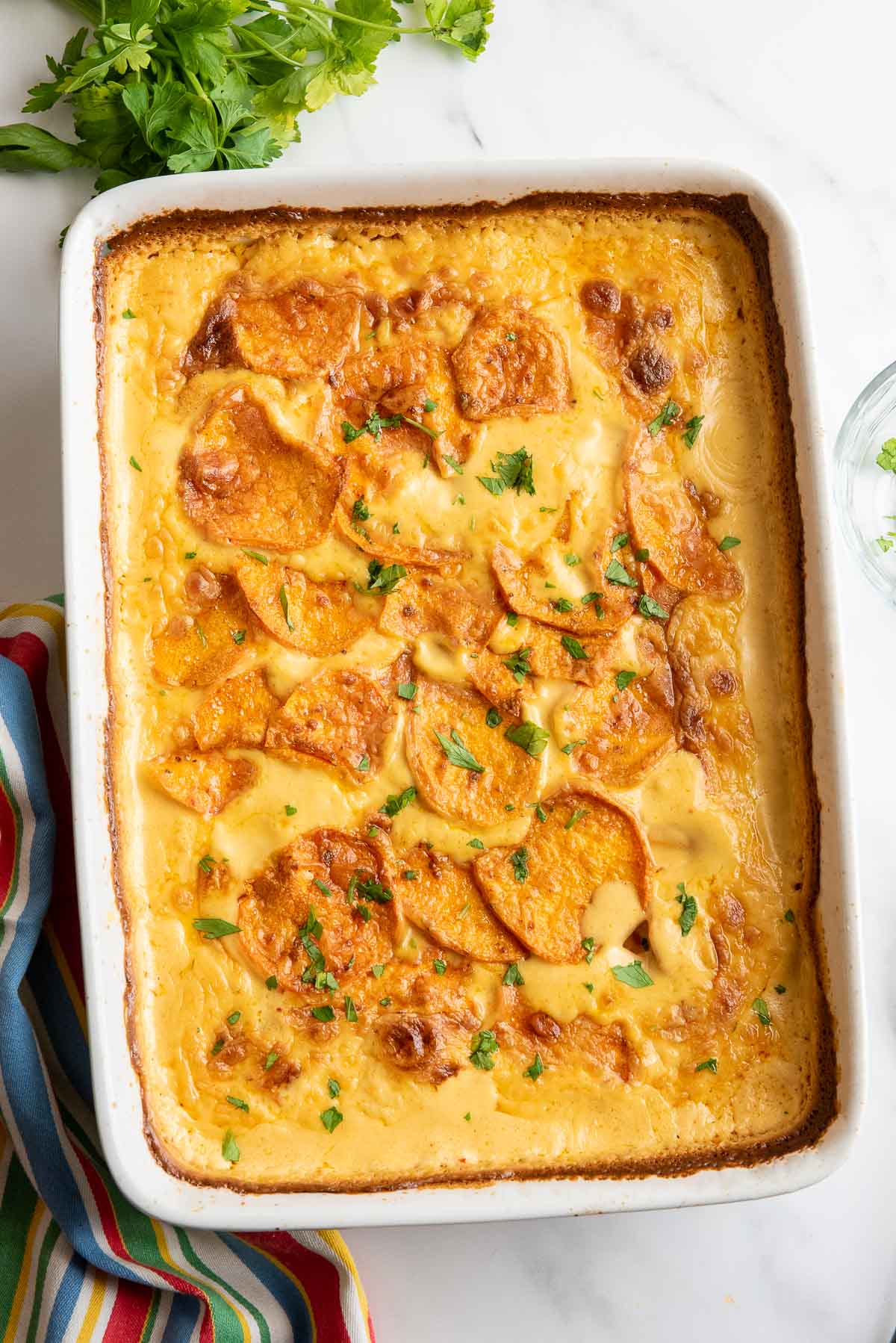 chipotle scalloped sweet potatoes baked in pan.