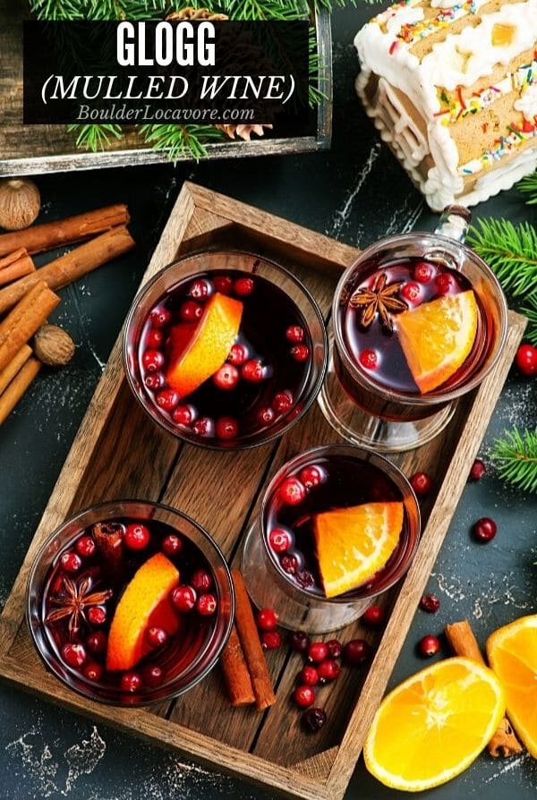 glass mugs of Glogg mulled wine on a wooden tray