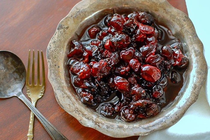 homemade brandied cranberries in a silver vintage bowl