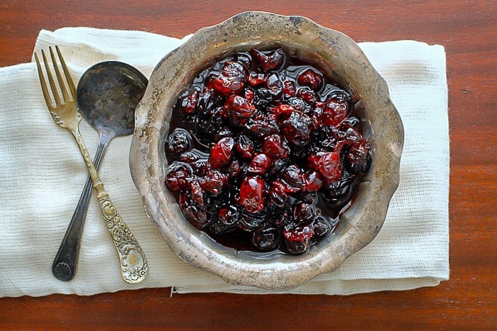 brandied cranberries in a vintage silver bowl with cutlery