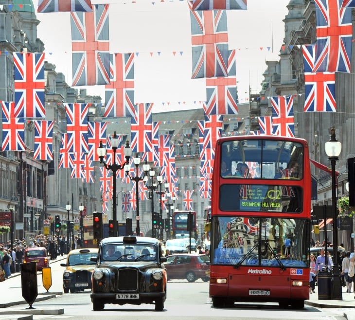 A double decker bus driving down a busy city street