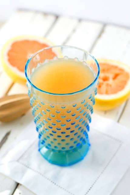 grapefruit juice in a blue glass