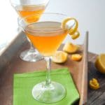 Leap Year cocktail in a cocktail glass with lemon spiral