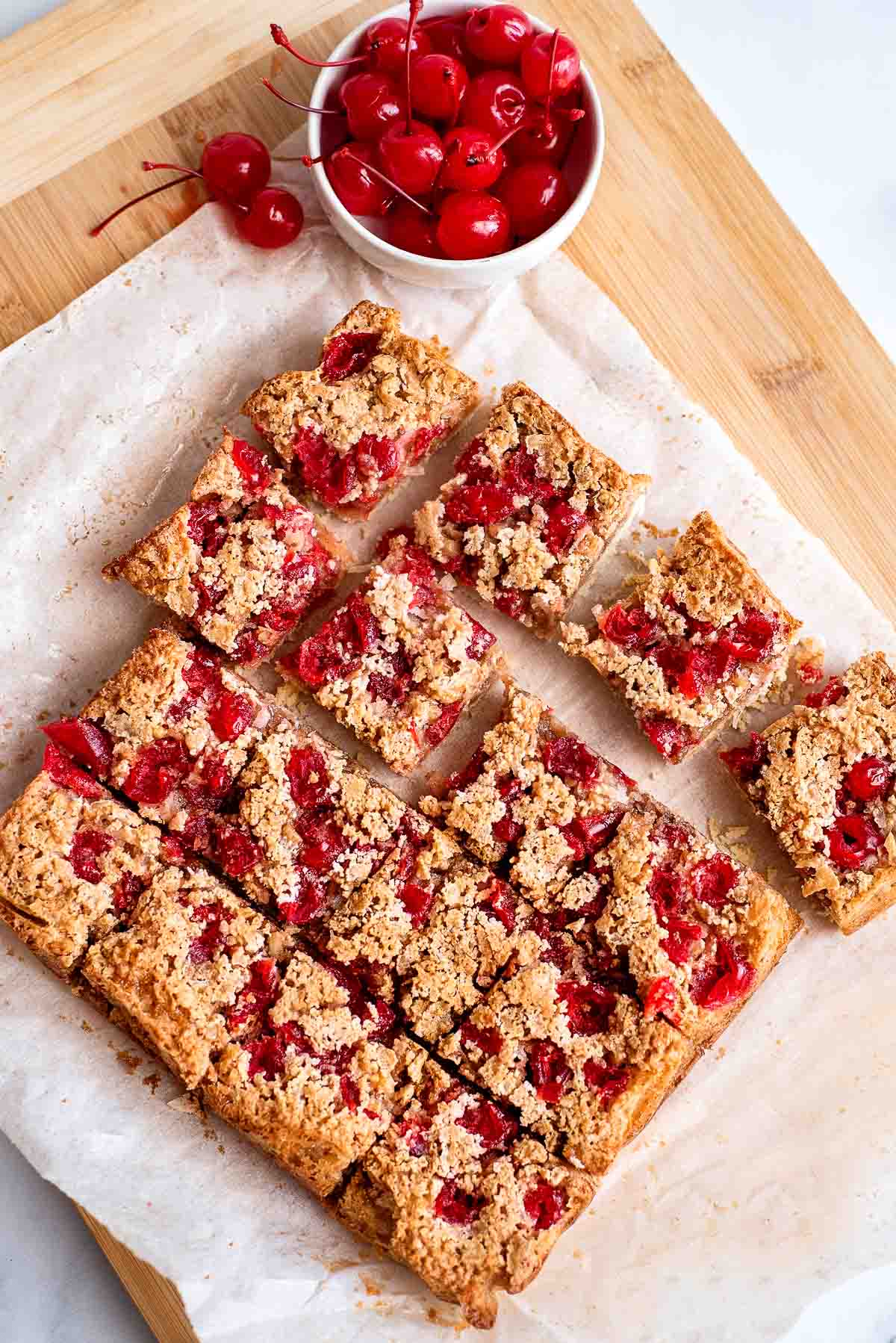 cherry bars cut on parchment paper