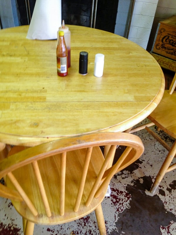 Wood table and chairs on painted floor Robinson's BBQ Amarillo TX