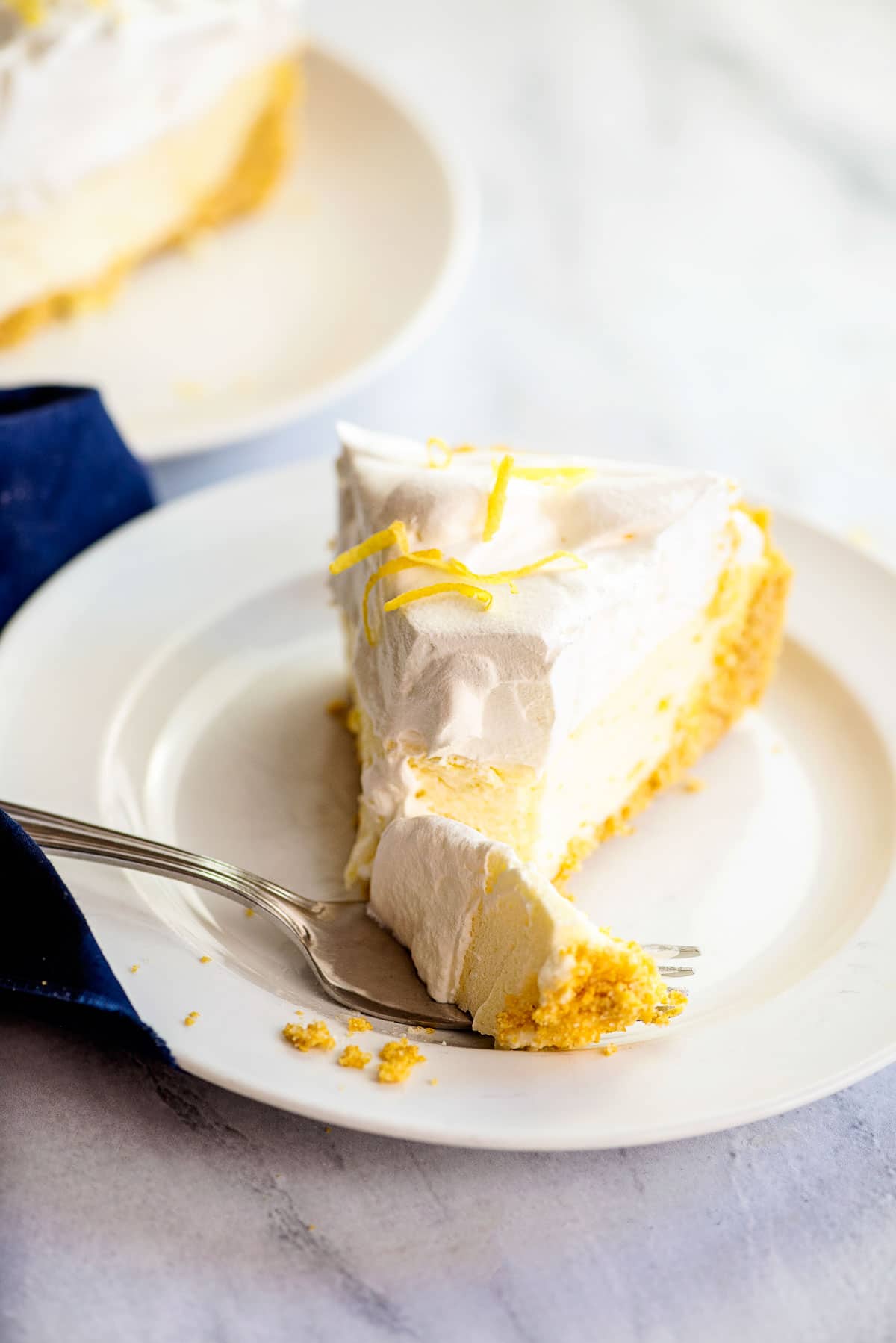 slice of lemon chiffon pie bite on fork 