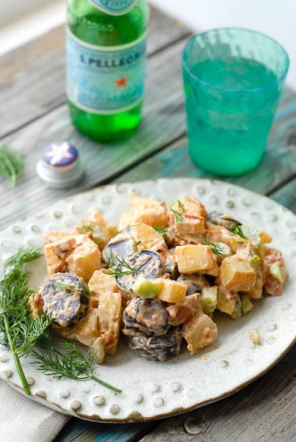 Tri Color Chipotle Bacon Potato Salad on a white ceramic plate