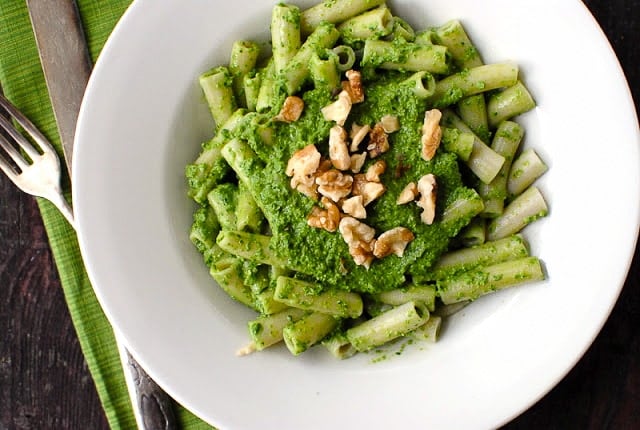 white bowl of Kale Walnut Meyer Lemon Pesto on Brown Rice Penne Pasta