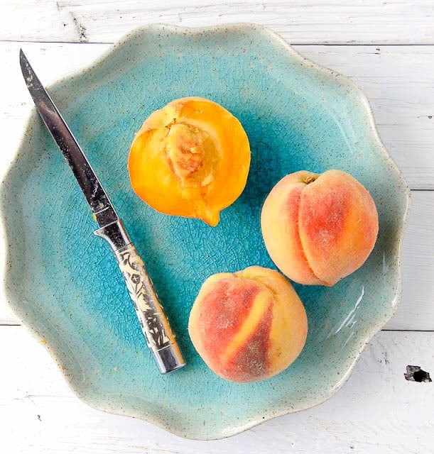 peaches on a blue plate