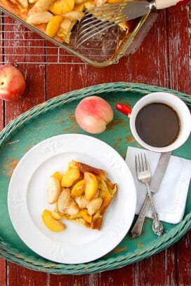 breakfast in bed tray holding a plate of Baked Pancakes with Sauteed Peaches