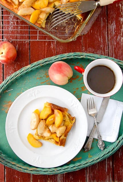 breakfast in bed tray holding a plate of Baked Pancakes with Sauteed Peaches 