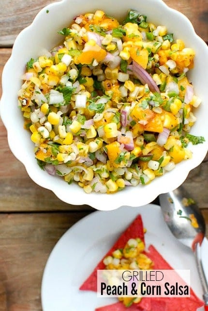 Sweet and spicy freshly made Grilled Peach and Corn Salas in a white bowl with red corn chips