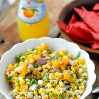 Grilled Peach and Corn Salsa in a white ruffle-edged with red corn tortilla chips, bottled lemonade
