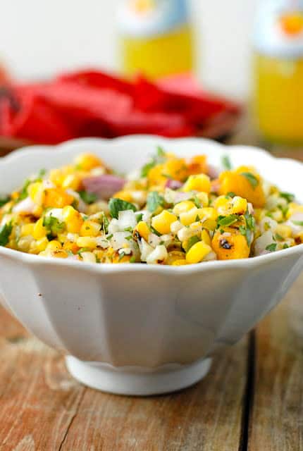 Colorful freshly Grilled Peach and Corn Salsa in a white bowl 