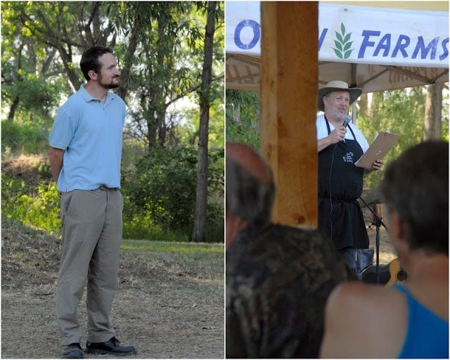 A man standing in front of a sign, at  Ollin Farms