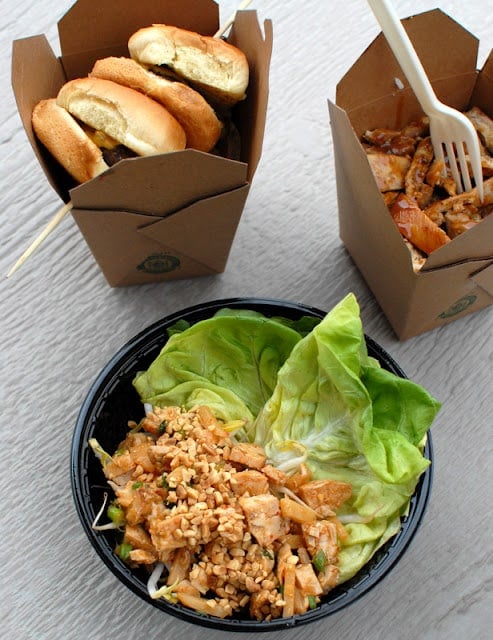 A box filled with different types of food on a table, with Asia