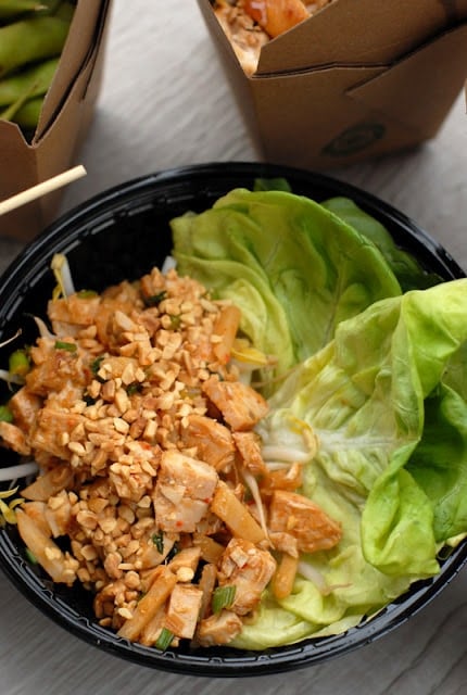 A plastic container filled with meat rice and vegetables