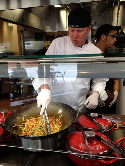 A man cooking in a kitchen preparing food