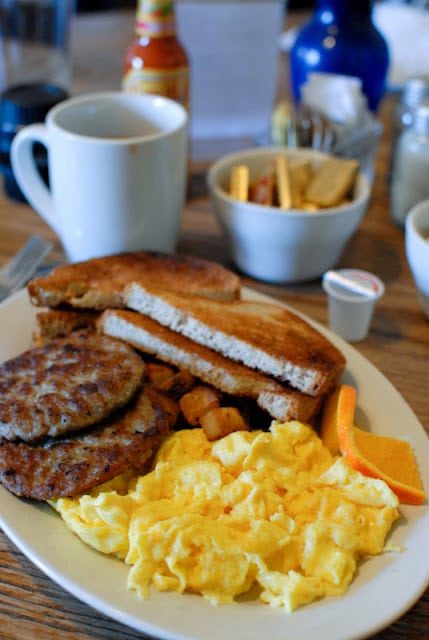 A close up of a plate of food and a cup of coffee