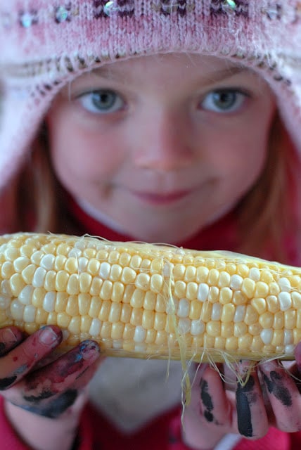 child and corn cob