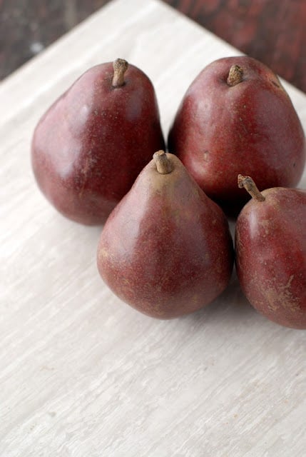 5 red pears on table