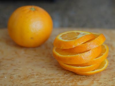 A bowl of oranges on a table, with Citrus fruit and Meyer lemon