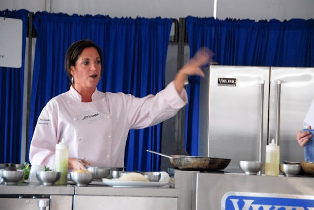 A person cooking in a kitchen preparing food