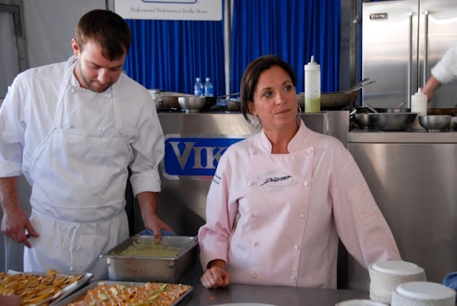 A group of people preparing food in a kitchen