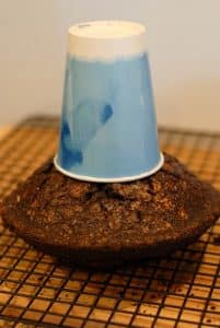 Smoking Volcano Cake - aligning paper cup with cake to cut hole