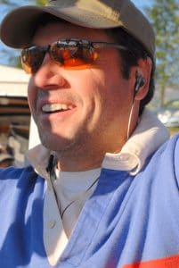 Hot air balloon pilot wearing a hat and sunglasses