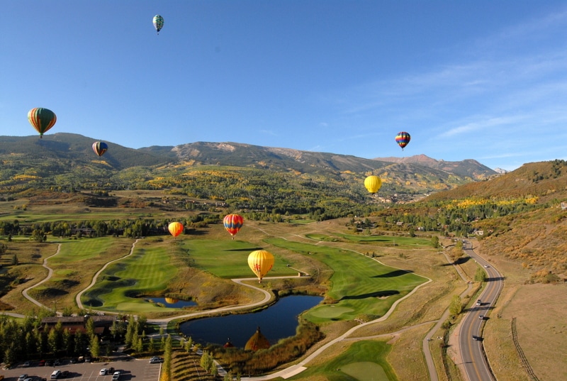 A group of people flying balloons 