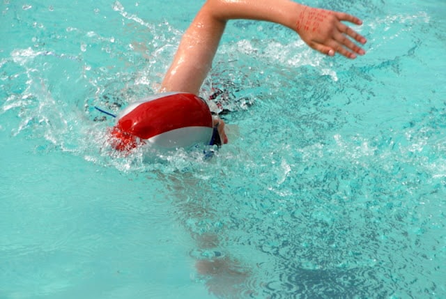 A person swimming in a pool of water