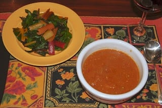 A bowl of food on a plate on a table, with Soup