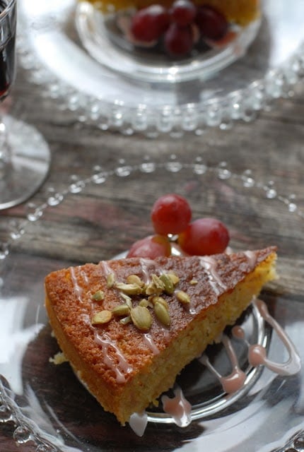 A piece of cake on a plate with grapes