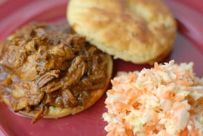 A plate of food, with Cabbage and Pulled pork